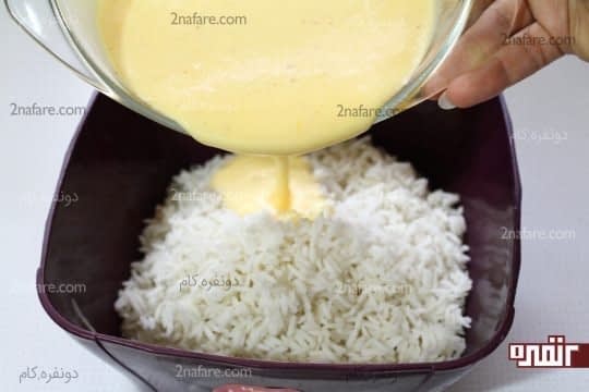 اضافه کردن مایه تهچین به برنج آپخته و آبکش شده