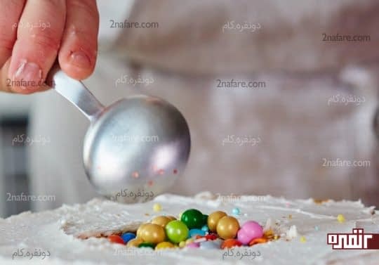 ریختن اسمارتیز و شکلات داخل حفره وسط کیک